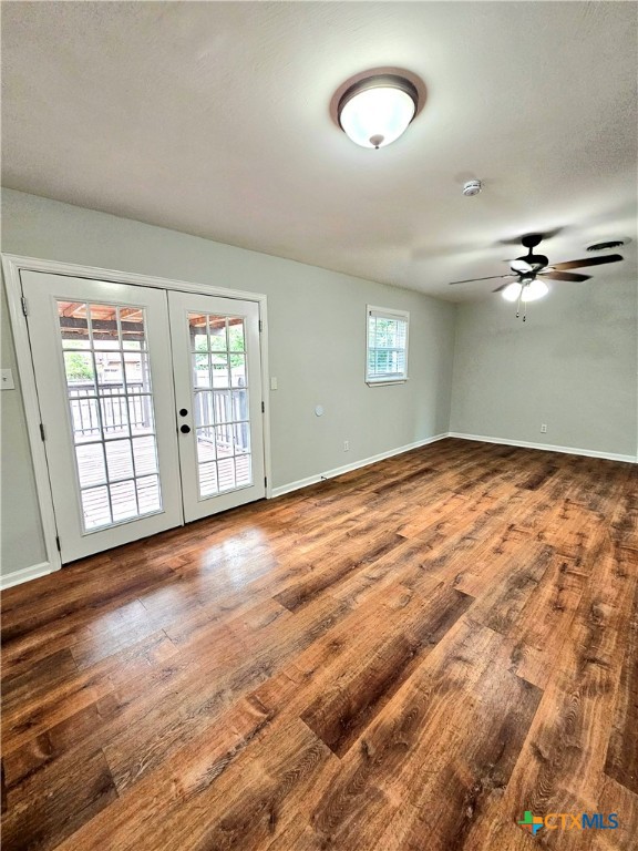 unfurnished room with french doors, ceiling fan, and wood-type flooring