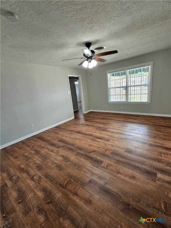 unfurnished room featuring dark hardwood / wood-style flooring, a textured ceiling, and ceiling fan