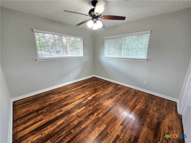 unfurnished room featuring dark wood-type flooring, ceiling fan, and a textured ceiling