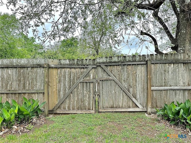 view of gate with fence