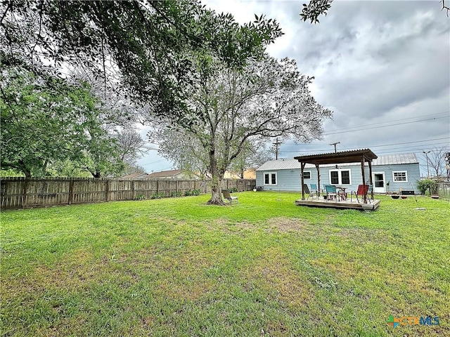 view of yard with a fenced backyard, a pergola, and a wooden deck