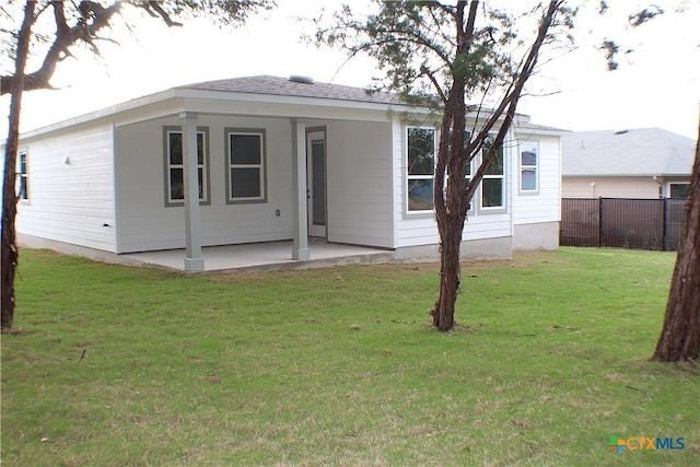 rear view of property with a patio area and a lawn