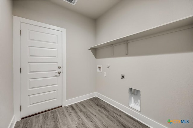 laundry area with hookup for a gas dryer, electric dryer hookup, hardwood / wood-style flooring, and washer hookup