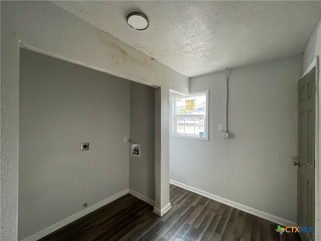 laundry area featuring a textured ceiling, dark hardwood / wood-style flooring, hookup for a washing machine, and electric dryer hookup