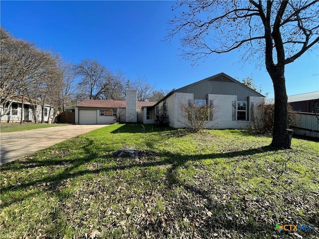 view of side of property featuring a yard and a garage