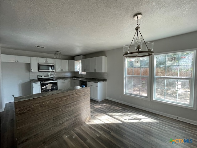 kitchen with sink, white cabinetry, stainless steel appliances, and hanging light fixtures