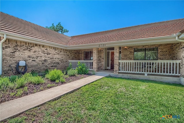 2721 Barton Hill Dr, Bulverde, TX 78163 - entrance to property featuring covered porch, brick siding, a lawn, and a tile roof