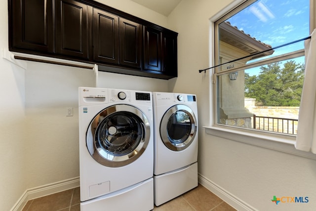 washroom featuring separate washer and dryer, cabinets, and light tile patterned flooring