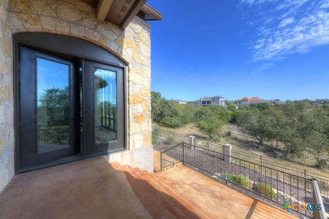 view of exterior entry featuring a balcony