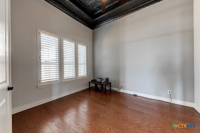 unfurnished room with dark wood-type flooring