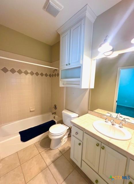 full bathroom featuring toilet, tile patterned floors, vanity, and visible vents