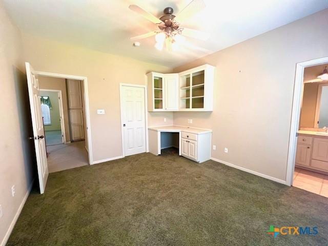 interior space with ceiling fan, carpet flooring, and baseboards
