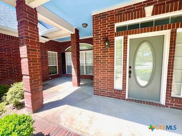 property entrance with brick siding