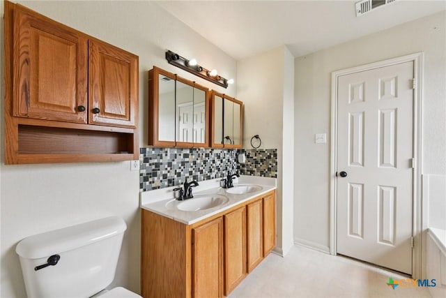 2204 Mikulec Dr, Killeen, TX 76542 - bathroom with decorative backsplash, double vanity, and toilet