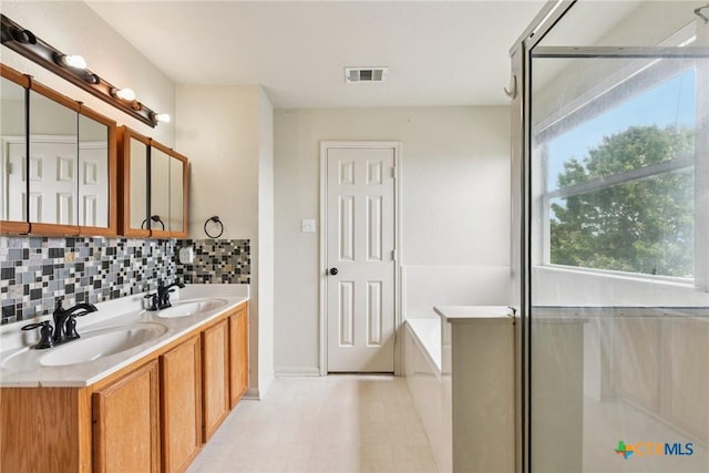 2204 Mikulec Dr, Killeen, TX 76542 - full bathroom featuring double vanity, a bath, and tasteful backsplash