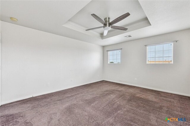 2204 Mikulec Dr, Killeen, TX 76542 - unfurnished room featuring a tray ceiling, dark carpet, a ceiling fan, baseboards, and a smoke detector