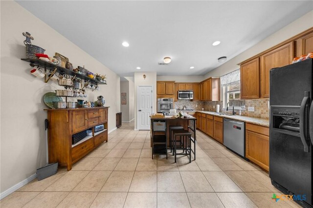 1901 Deer Field Way, Harker Heights, TX 76548 - kitchen featuring stainless steel appliances, decorative backsplash, light countertops, brown cabinets, and light tile patterned floors