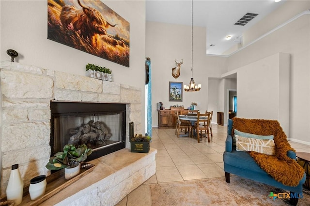 1901 Deer Field Way, Harker Heights, TX 76548 - living room with a chandelier, a fireplace, light tile patterned flooring, and a towering ceiling
