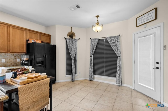 1901 Deer Field Way, Harker Heights, TX 76548 - kitchen featuring brown cabinets, decorative backsplash, light countertops, black fridge with ice dispenser, and light tile patterned floors