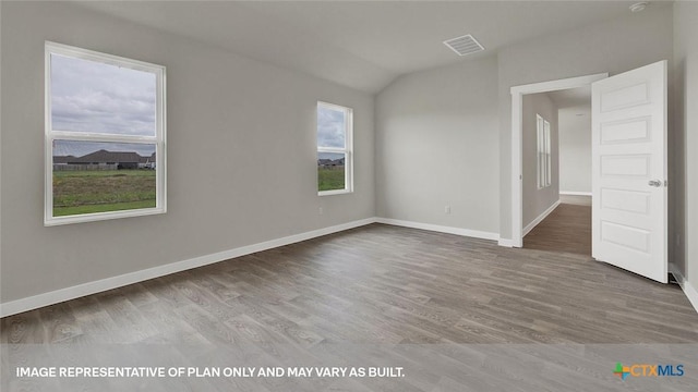 575 Radley Rd, Lockhart, TX 78644 - spare room with wood finished floors, lofted ceiling, and baseboards