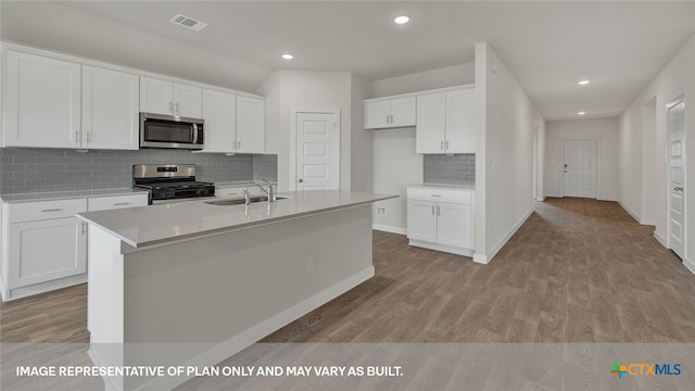 kitchen with white cabinetry, sink, an island with sink, and appliances with stainless steel finishes