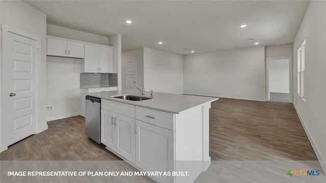 kitchen featuring white cabinetry, sink, light hardwood / wood-style flooring, stainless steel dishwasher, and a center island with sink