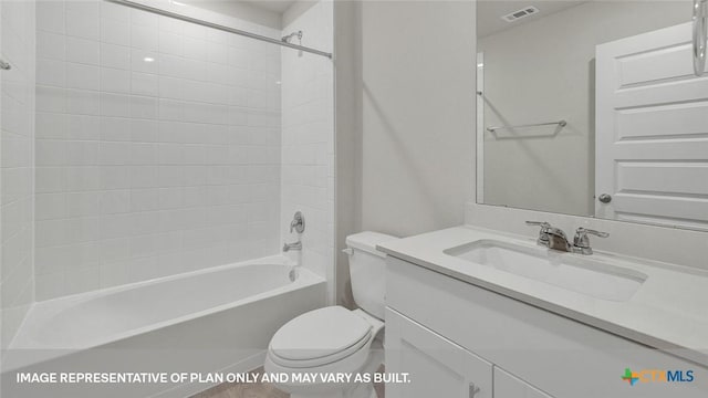 full bathroom featuring tiled shower / bath combo, toilet, and vanity