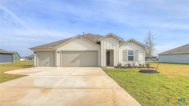 view of front of home with a garage and a front lawn