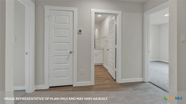 575 Radley Rd, Lockhart, TX 78644 - hall with wood finished floors, baseboards, and recessed lighting