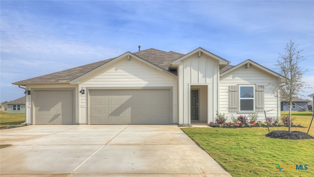 view of front of home with a front lawn and a garage