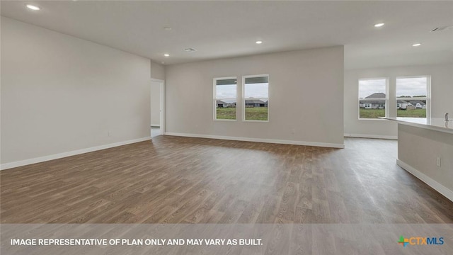 575 Radley Rd, Lockhart, TX 78644 - spare room featuring healthy amount of natural light, wood finished floors, recessed lighting, and baseboards
