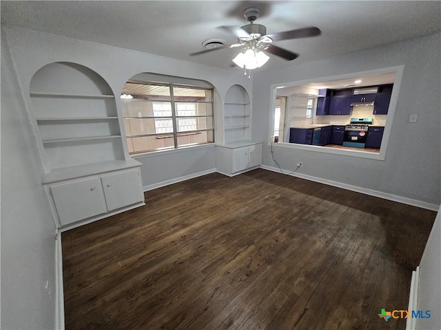 empty room featuring built in features, dark wood-type flooring, ceiling fan, and baseboards