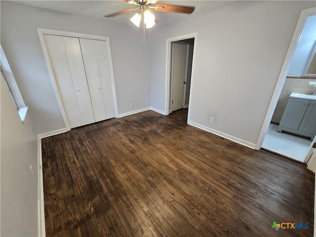 unfurnished bedroom with ensuite bathroom, ceiling fan, dark hardwood / wood-style flooring, and sink