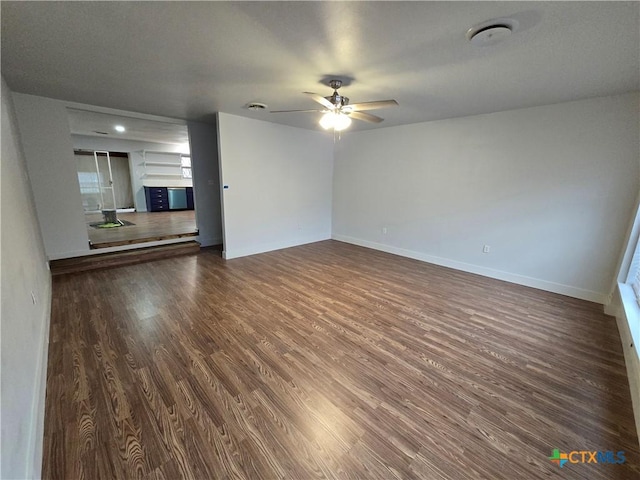 interior space with ceiling fan and dark hardwood / wood-style flooring