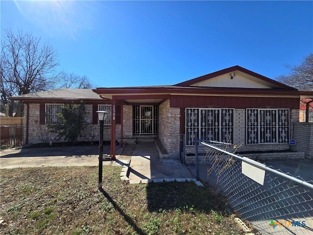 single story home with a patio area, brick siding, and fence