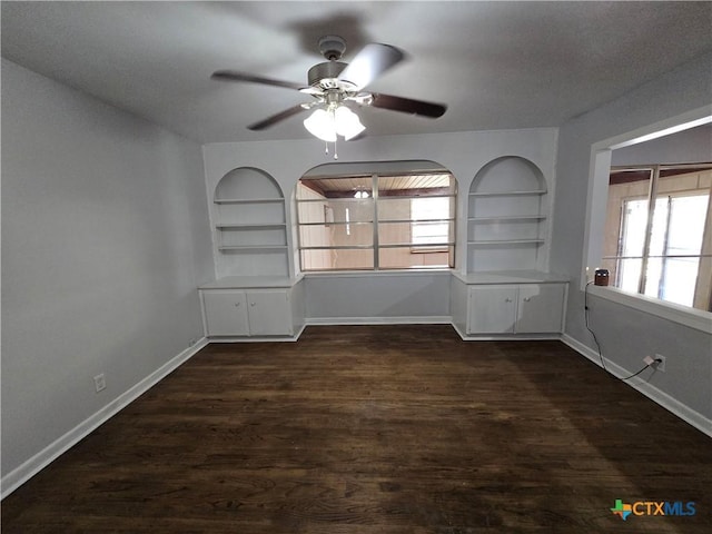 spare room with plenty of natural light, baseboards, and built in features