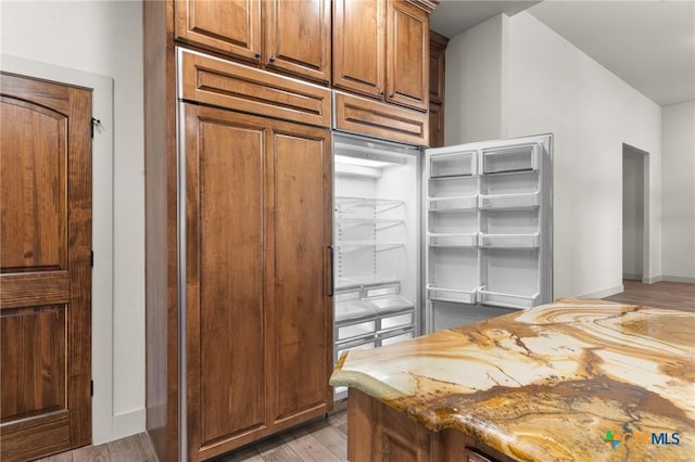 kitchen featuring light hardwood / wood-style floors and light stone counters