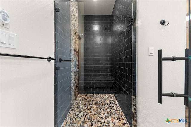 bathroom with tiled shower