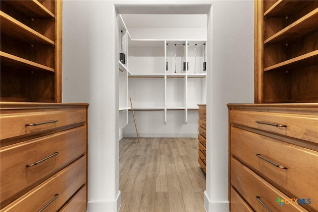 spacious closet featuring light wood-type flooring