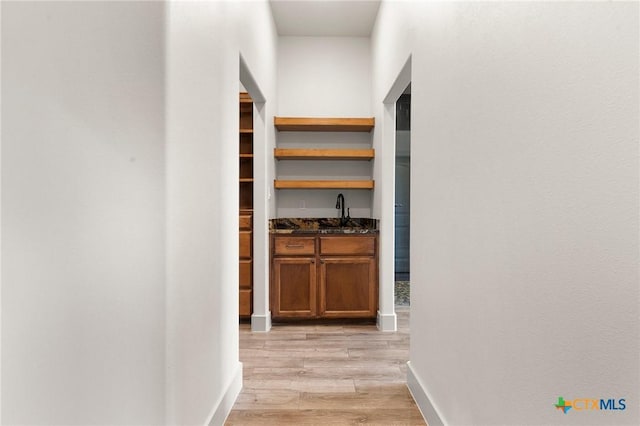 hall featuring light hardwood / wood-style floors and sink