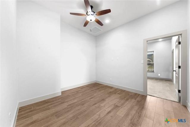 empty room featuring ceiling fan and light hardwood / wood-style floors