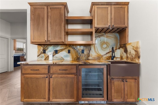 bar featuring sink, backsplash, light parquet flooring, and wine cooler