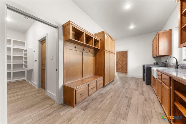 mudroom featuring light wood-type flooring and sink