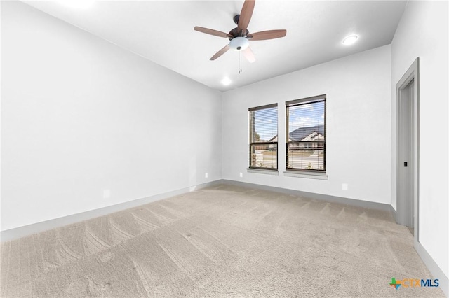 carpeted empty room featuring ceiling fan