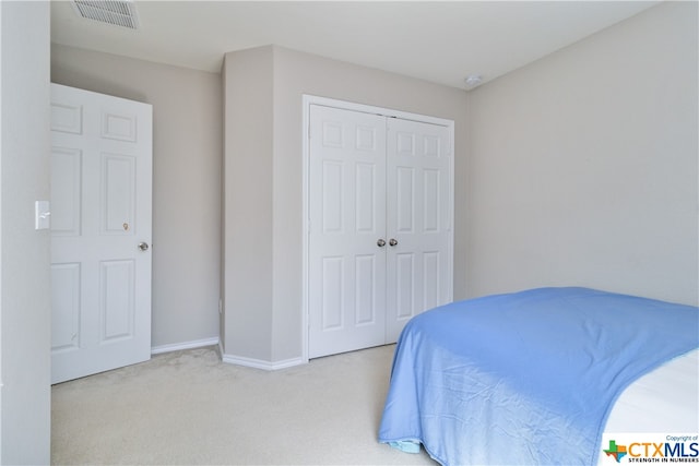 carpeted bedroom with a closet