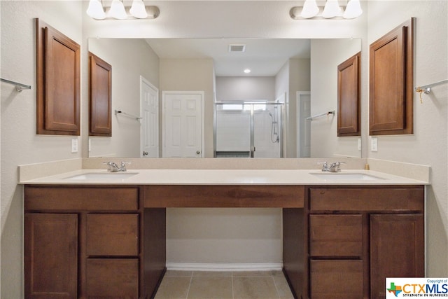 bathroom featuring vanity, tile patterned flooring, and an enclosed shower