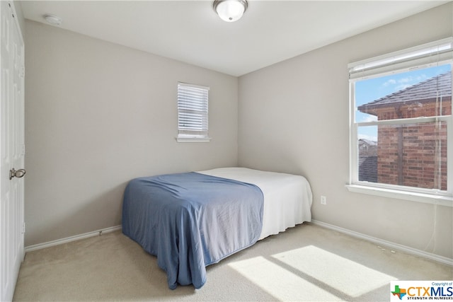 bedroom featuring light carpet