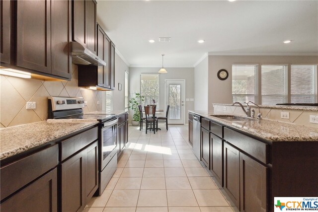 kitchen with stainless steel appliances, sink, light stone counters, light tile patterned floors, and decorative light fixtures