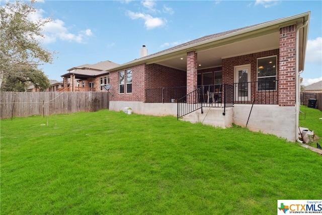 back of house with a lawn