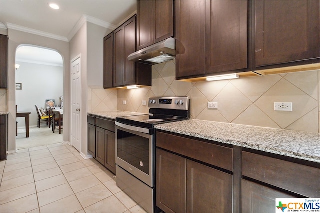 kitchen with light tile patterned flooring, light stone counters, tasteful backsplash, stainless steel range with electric cooktop, and dark brown cabinets